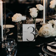 the table is set with white flowers and candles