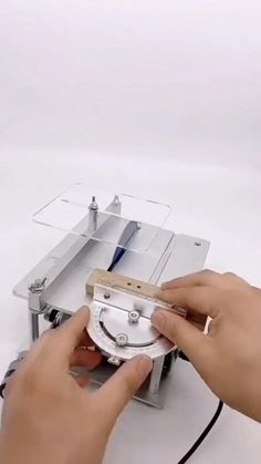 a person is working on a machine with scissors