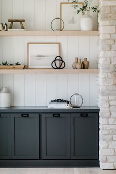 the shelves in this living room are filled with vases and other decor items on top of them