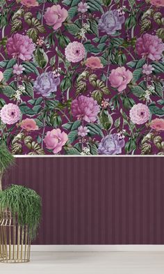 a potted plant sitting in front of a purple wallpapered with pink and purple flowers