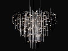 a large chandelier with lights hanging from it's sides and circular rods