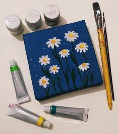 the contents of an art project including paint, markers and pens are laid out on a table