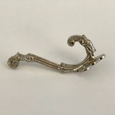 an antique silver handle on a white background