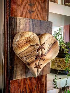 a wooden heart hanging on the side of a door