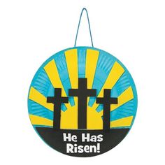 a blue and yellow paper plate with the words he has risen written on it in black