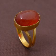 Handmade PRODUCT CODE :- HA1 Material :- Brass Size :- Any Carnelian Brass Ring,Handmade Ring,Unique Ring,orange Stone Ring,Boho Ring,Anniversary Ring,Wedding Ring,Vintage Ring,Gift Ring, Deco Ring, This Red carnelian gold ring have a statement Anyone will notice your classic style with that amazing unique ring, Carnelian stone is known for encouraging motivation, prosparity and good luck.:) ♥We Crafted These in 100% Solid Brass These Simple rings are perfect for any occasion. Make a Statement w Oval Cabochon Opal Ring Gift With Polished Finish, Polished Carnelian Oval Rings, Handmade Gold Chalcedony Rings, Gold Carnelian Ring For Wedding, Carnelian Gold Wedding Rings, Oval Chalcedony Moonstone Ring For Wedding, Amber Birthstone Ring, Gold Carnelian Ring For Anniversary, Carnelian Cabochon Ring As Gift