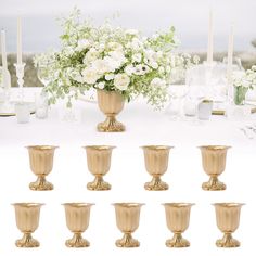 there are many vases with flowers in them on the table next to each other