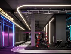 an empty gym with neon lights and exercise equipment