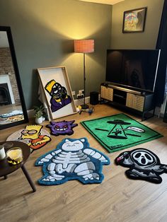 a living room with various rugs on the floor and pictures in front of it