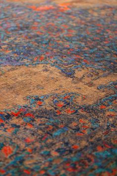 an old rug with colorful designs on it