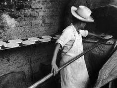 an old photo of a woman in the oven