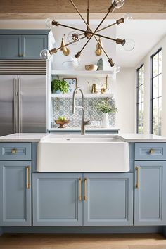 a kitchen with blue cabinets and white counter tops is featured on the instagram page