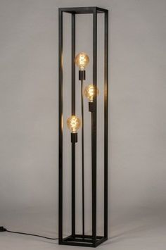 an iron and glass floor lamp with three lights