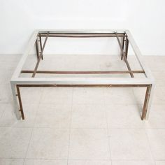 a white coffee table sitting on top of a tiled floor