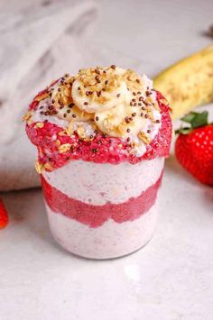 a strawberry and banana smoothie with sprinkles on top next to some strawberries