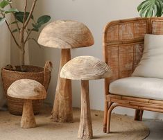 three mushrooms sitting on top of a rug next to a chair and potted plant