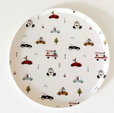 a white plate with cars and trees on it