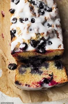 two slices of blueberry bread are sitting on wax paper