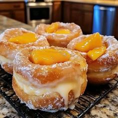 three glazed donuts sitting on top of a cooling rack