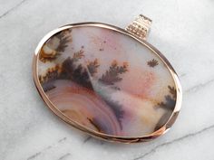 Warm fiery hues, in golden yellow and burnt ember, create a pattern that looks like an underwater universe. Absolutely breathtaking, this oversized rose gold pendant is sure to make an impact! This pendant does not come with the chain shown. Please feel free to contact us, we will help you find the perfect chain for your style and budget! Metal: 14K Rose Gold Gem: Dendritic Agate Gem Measurements: 50 x 72 mm, Oval Measures: 65 x 74 mm, with bail Luxury Engraved Agate Jewelry, Luxury Gold Agate Jewelry, Luxury Yellow Gold Agate Jewelry, Luxury Artisan Agate Jewelry, Luxury Agate Pendant Gemstone, Make An Impact, Ceylon Sapphire, Cameo Ring, Dendritic Agate