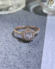 a close up of a diamond ring on a table