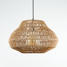 a woven light fixture hanging from a ceiling