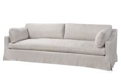 a white couch with two pillows on it