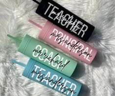 three lip glosses with the words teacher written on them in black, pink, and green