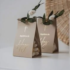 two small bags with flowers on them are sitting next to a wicker basket and paper bag