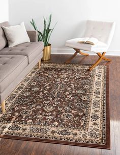 a living room with a couch, chair and rug