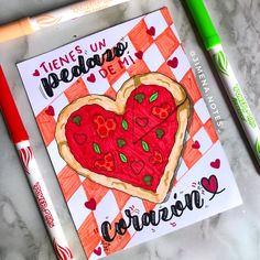 a valentine's day card with a heart shaped pizza on it and two markers next to it