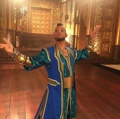 a man standing in front of a wooden floor with his arms out and hands outstretched