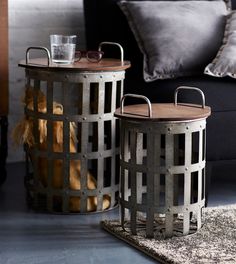 two metal baskets sitting on top of a rug