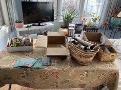 the table is covered with boxes and other items