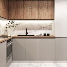 an image of a kitchen setting with marble countertops and wood paneling on the walls