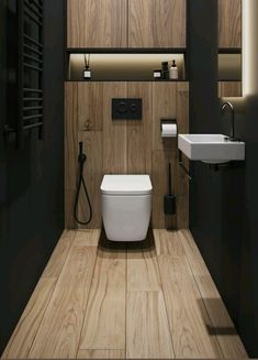 a modern bathroom with wood paneling and white fixtures, including a toilet and sink