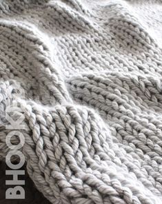 a close up of a knitted blanket on a bed with the words photoshop above it