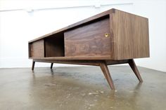 a wooden table with two drawers on one side and an open drawer on the other