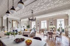 a living room filled with lots of furniture and decor on top of a hard wood floor