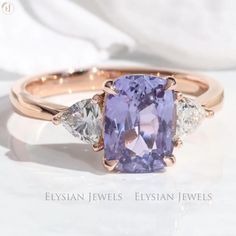 an image of a ring with a purple stone and three diamonds on the side,