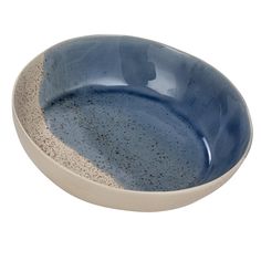 a blue and white bowl with speckles on the bottom, sitting in front of a white background