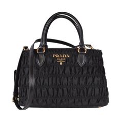 This Prada black tessuto gaufre nylon handbag is luxurious and practical. There are three interior compartments with a zip divider, which is great for organizing and separating your personal belongings. The nylon material is durable and looks sleek with the black saffiano leather trim. The gold Prada Paris logo also goes beautifully with the black nylon. This designer bag is great for everyday use and can also be carried by the handles or adjustable strap. Model: 1BA173 Black tessuto gaufre nylon Black saffiano leather trim Gold-tone hardware Protective feet Open closure One interior zip pocket Three compartments Removable/adjustable shoulder strap Double-handle drop: 5" Measurements: 11.5 x 6 x 7" (LWH) Includes ity cards and Prada dust bag Made in Italy Prada Tessuto Bag, Pocket Handbag, Paris Logo, Nylon Handbag, Black Satchel, Satchel Handbag, Crossbody Messenger Bag, Gucci Black, Satchel Handbags