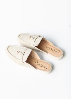 The Taupe Faux Suede Loafer Mule is a classic shoe that can be dressed up or down! This slip-on loafer mule features circular metallic hardware charm on the ribbon, moccasin stitching on the faux suede upper, and an almond shaped toe. The footbed is crafted from faux nubuck leather and lightly padded for all day comfort. It also has a durable rubber outsole with a 1.1" heel for slight elevation. Pair theses versatile shoes with your favorite outfits for farmers markets, church, or work. Style | Versatile Shoes, Farmers Markets, Almond Shaped, Work Style, Loafer Mules, Suede Loafers, Classic Shoes, Nubuck Leather, Dress Accessories