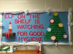 a bulletin board with an elf on the shelf is watching for good hygiene