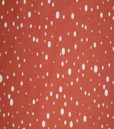 an orange background with white polka dots