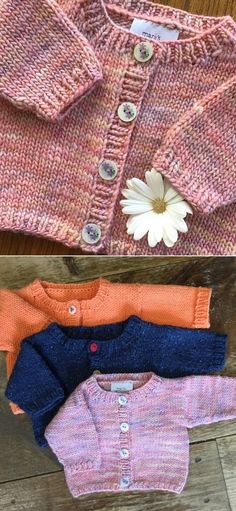 three knitted sweaters with buttons and flowers on the top one has a flower in it