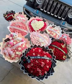 valentine's day flowers are arranged on the hood of a jeep