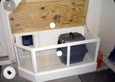 a white shelf with a wooden box on top and some plastic containers in the bottom