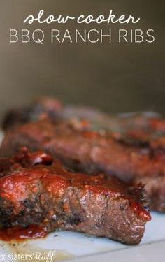 two pieces of meat on a plate covered in ketchup and barbecue sauces