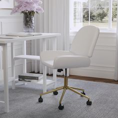 a white office chair sitting on top of a rug in front of a table with flowers